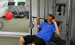 Man lifing weights on gym equipment
